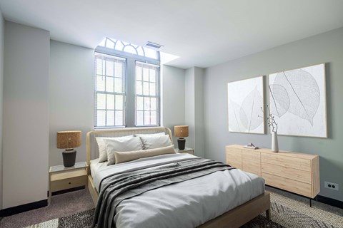 A bedroom with a bed, nightstand, and lamp.