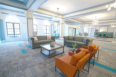 A living room with grey and orange furniture.