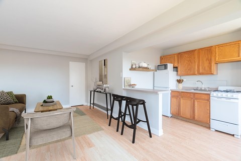 A kitchen with wooden cabinets and a white fridge.