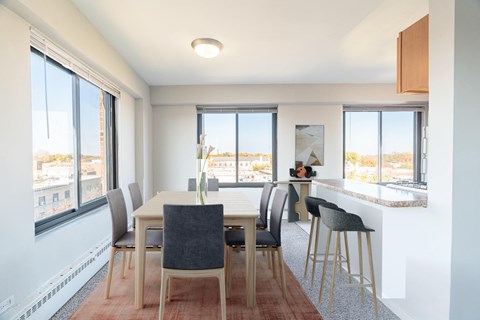 A dining room with a table and chairs.