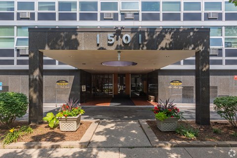 The image shows a building entrance with a large number 150 on the wall.