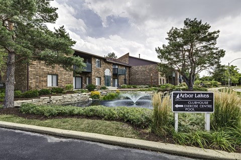 A sign in front of a building that says Arbor Lakes Exercise Centre.
