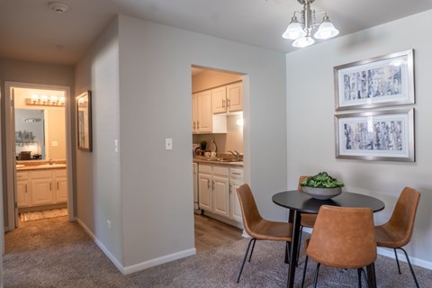 A dining room with a table and chairs is shown.