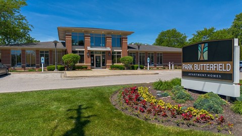 The image shows a building with a sign that reads "Park Butterfield Apartment Homes".