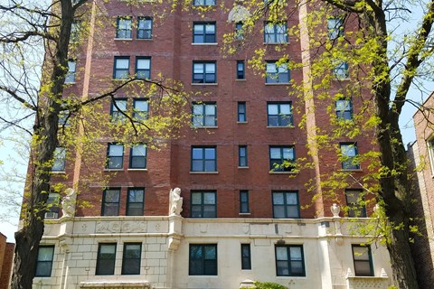 A red brick building with a white section at the bottom.