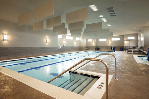 A large indoor swimming pool with lanes marked for swimming.