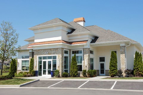 A modern building with a white facade and a grey roof.