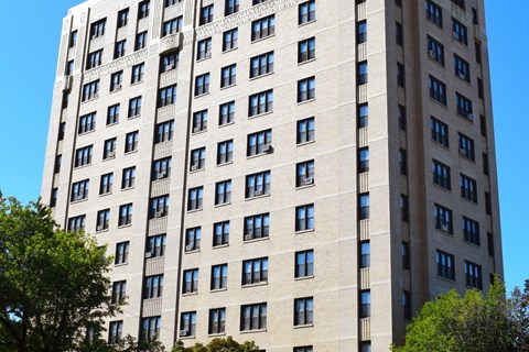 A tall building with many windows and balconies.