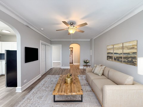 A modern living room with a wooden coffee table and a beige sofa.