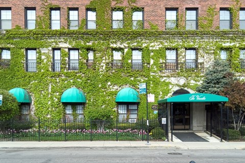A building with green plants growing on it.