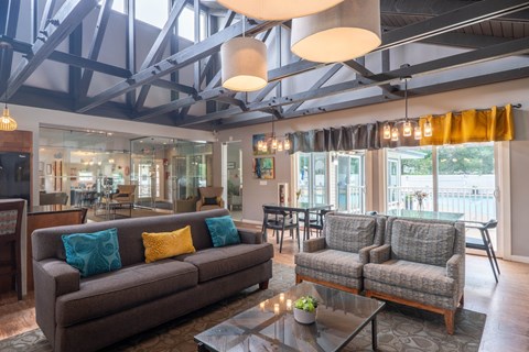 A living room with a brown couch and a coffee table.