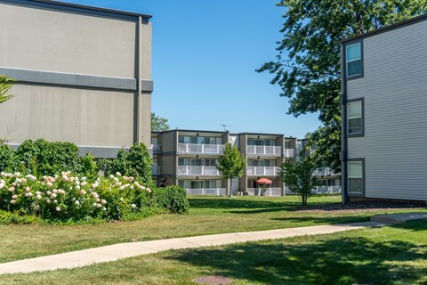 A modern building with a well-maintained lawn in front.
