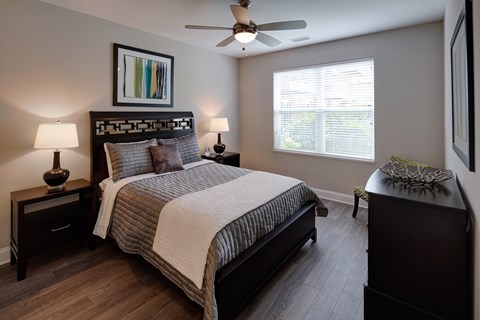 Bedroom with dark wood furniture and ceiling fan at TLC Grand Apartments, Deerfield, 60015