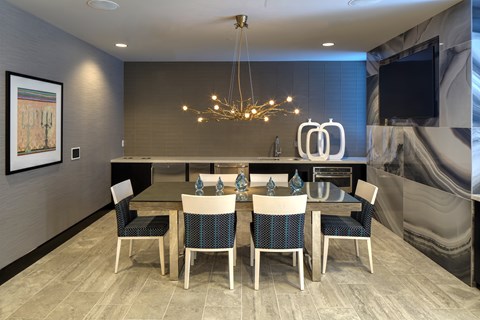 Modern dining room with contemporary chandelier and bar at TLC Grand Apartments, Deerfield, 60015
