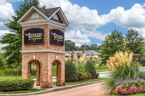 a brick building with a sign for the estates at spring valley