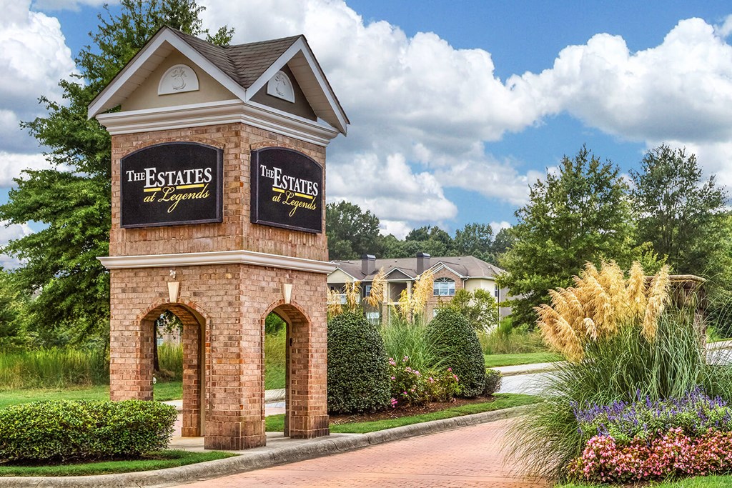a brick building with a sign for the estates at spring valley