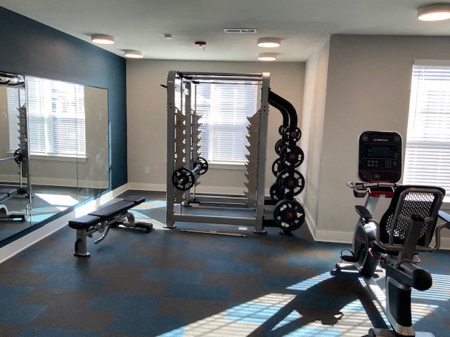a gym with weights and other exercise equipment in a room