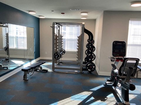a gym with weights and other exercise equipment in a room