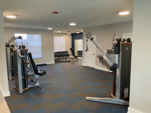 a gym with weights and other equipment in a room