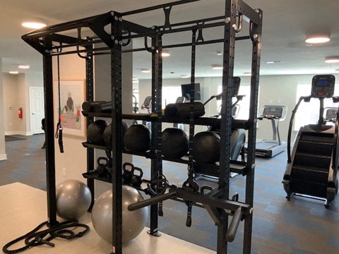 a gym with weights and other equipment in it