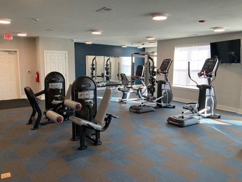 a gym with a lot of exercise equipment in it