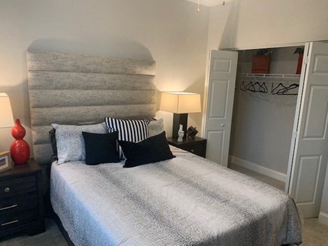 a small bedroom with a bed and pillows on it