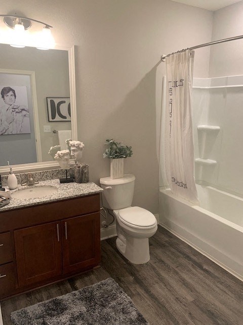 a bathroom with a toilet and a shower and a sink