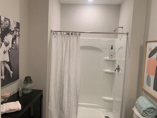a small bathroom with a shower and a sink