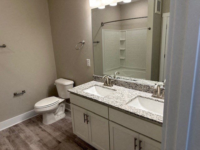 a bathroom with two sinks and a toilet