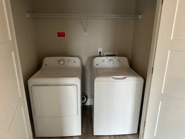 two washer and dryers in a small closet