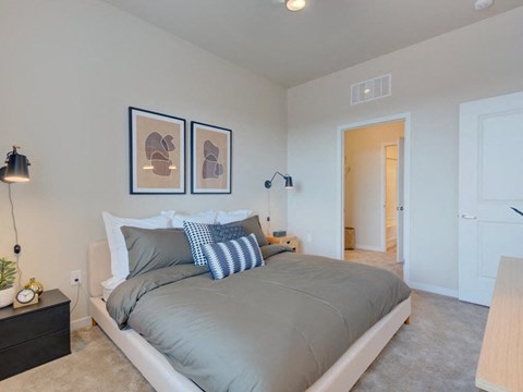 a bedroom with a bed and a door to a hallway