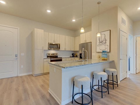 a kitchen with a bar and stools