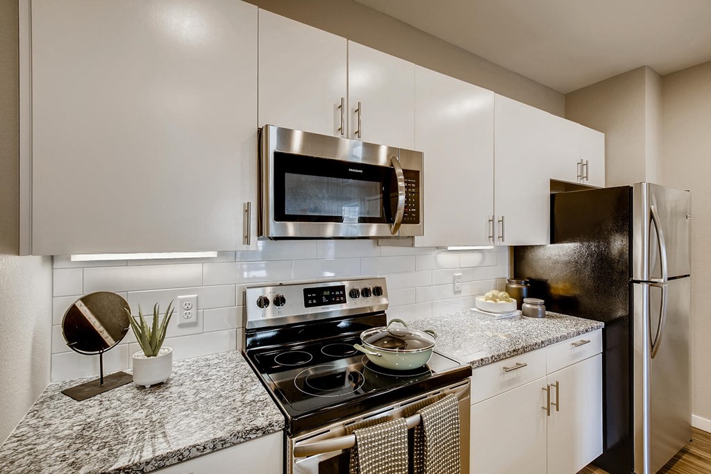 a kitchen with stainless steel appliances and granite counter tops