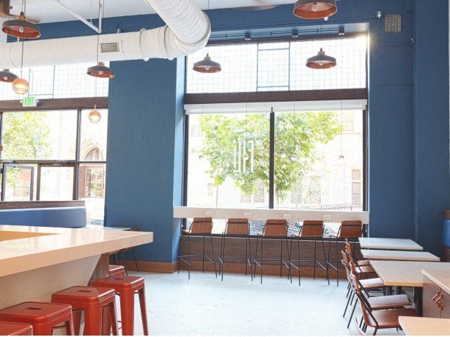 a restaurant with blue walls and a large window