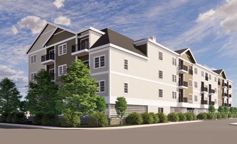 A large, modern apartment building with balconies and multiple stories.