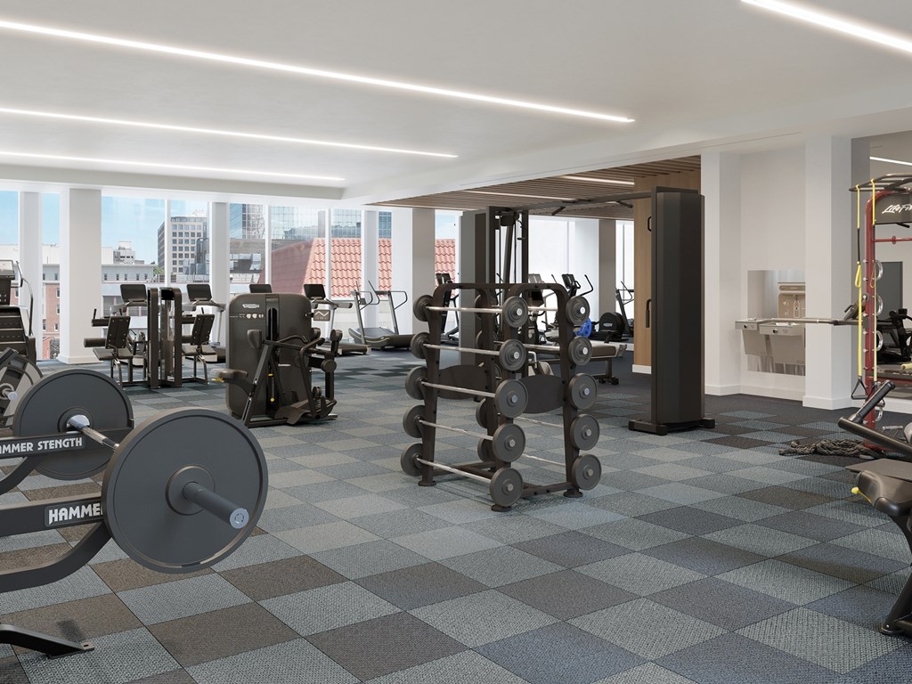 A gym with a variety of equipment including weights and machines.