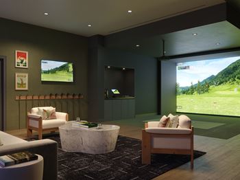 A modern living room with a large screen TV and comfortable seating.