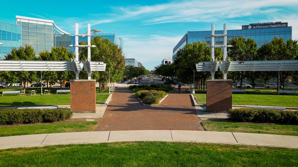 A walkway leads to a building with the sign "Jefferson Health" on it.