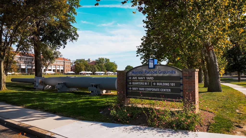 A sign in front of a tree reads "Marine Parade Grounds".