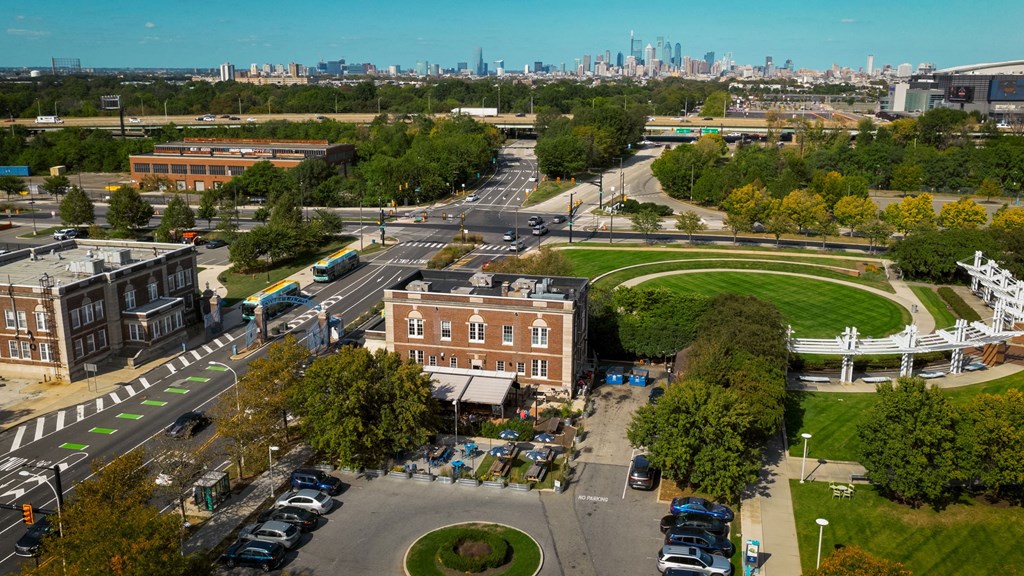 A city intersection with a view of the city skyline in the distance.
