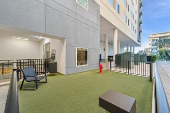 A modern building with a green lawn and a fire hydrant.