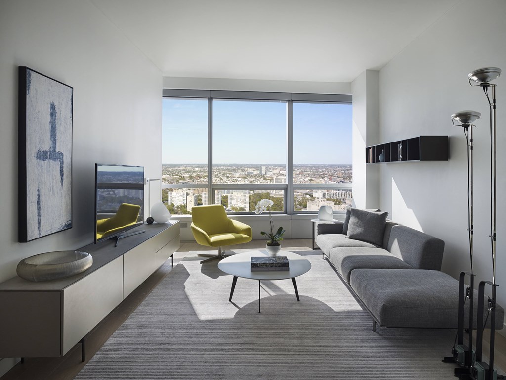a living room with a couch and a table and a window