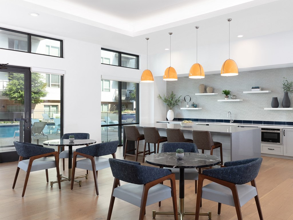 a kitchen and dining area with white walls and hardwood flooring