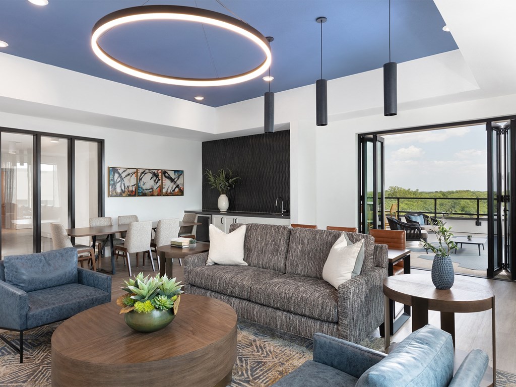 a living room filled with furniture and a large window