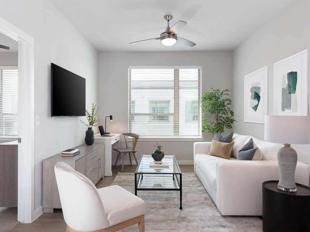 a living room with a white couch and a glass coffee table at AVE Austin North Lamar, Austin, TX