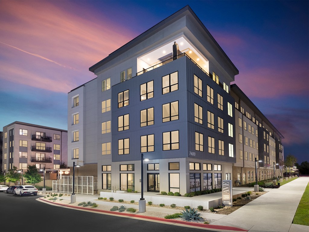 a rendering of an apartment building at dusk