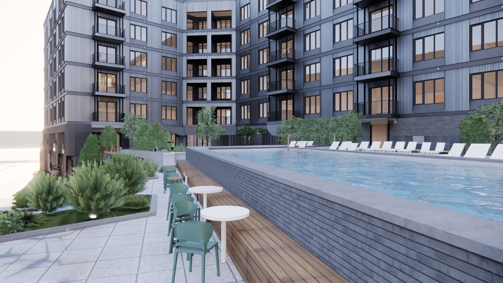 A modern building with a pool and seating area.