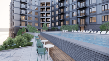 A modern building with a pool and seating area.