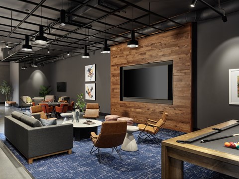 A modern living room with a pool table and a television.