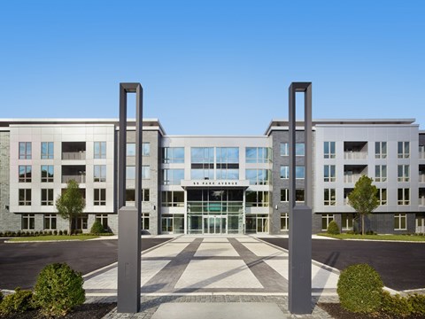 A modern building with two large pillars in front.